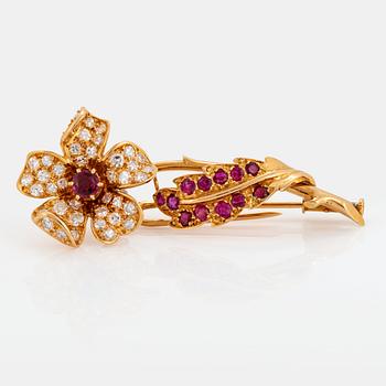 1054. An 18K gold brooch set with faceted rubies and eight-cut diamonds.