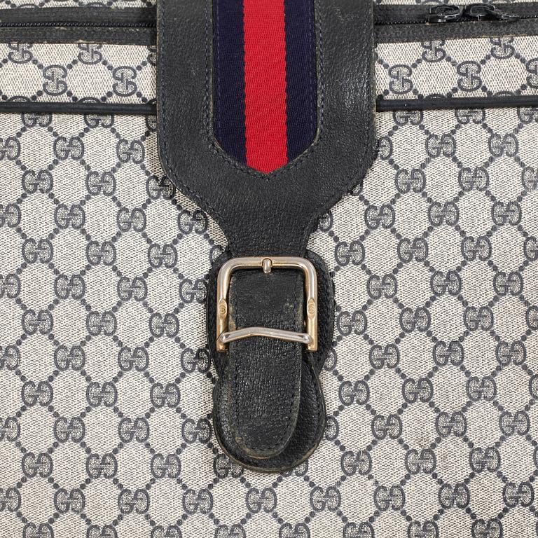 GUCCI, a blue monogram canvas suitcase.