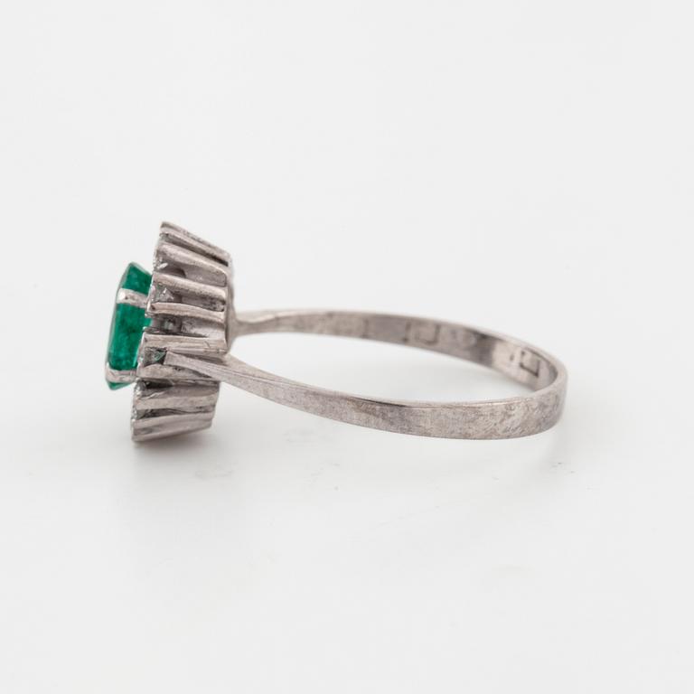 A emerald and brilliant cut diamond ring.