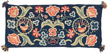 An embroidered carrige cushion, ca 108 x 48 cm, signed AMA, Scania, first half of the 19th century.