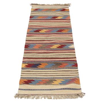 A persian kilim runner, c 246 x 64 cm.