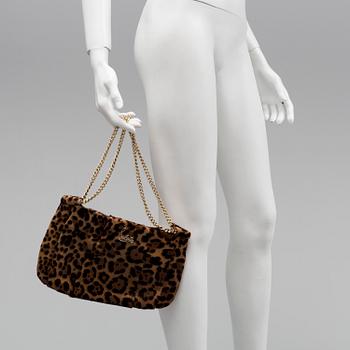 A leopard patterned ponyhair handbag by Christian Louboutin.