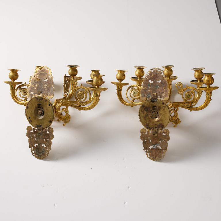 A pair of French Empire ormolu five-branch wall-lights, Paris, early 19th century.