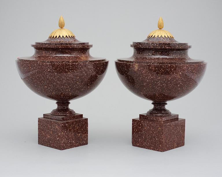 A pair of late Gustavian early 19th century porphyry urns with covers.