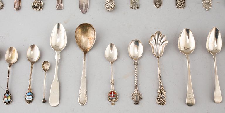 A collection of silver of 57 pcs, i.a souvenir spoons, 20th century. Total weight 1073 g.