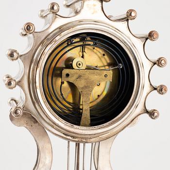 A silver-plate table clock, Empire, mid 19th century.