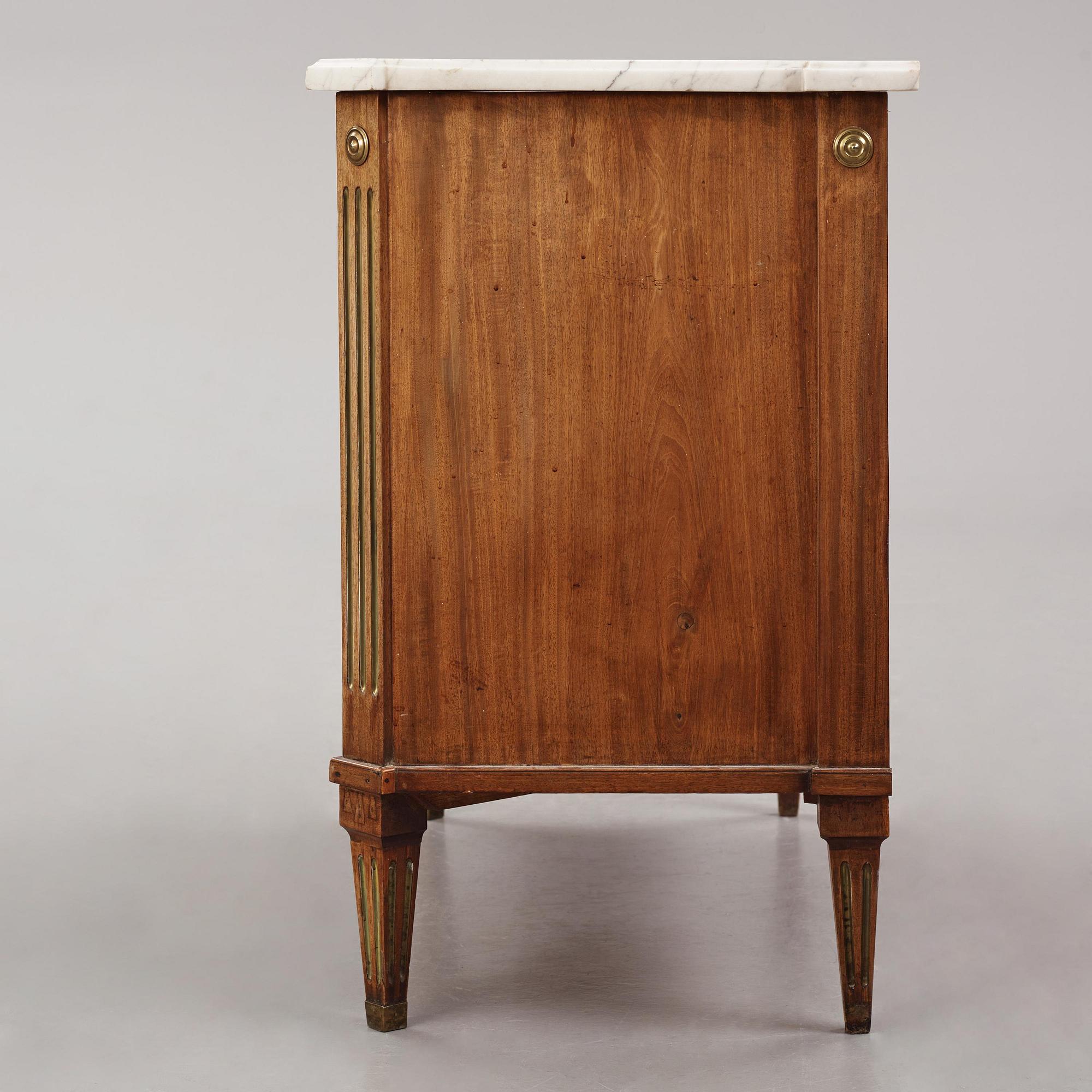 A late Gustavian mahogany, marble top, and brass-mounted commode, Stockholm, late 18th century.