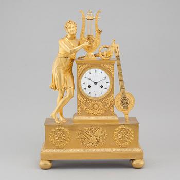 An Empire table clock, dial marked "L Ravrio Bronzier à Paris Mesnil H", fist half of the 20th century.