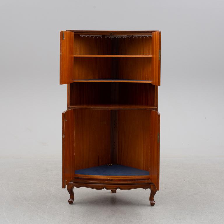 a mahogany corner cabinet.