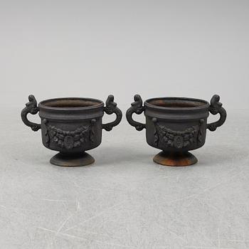 A 20th Century pair of cast iron flower pots.