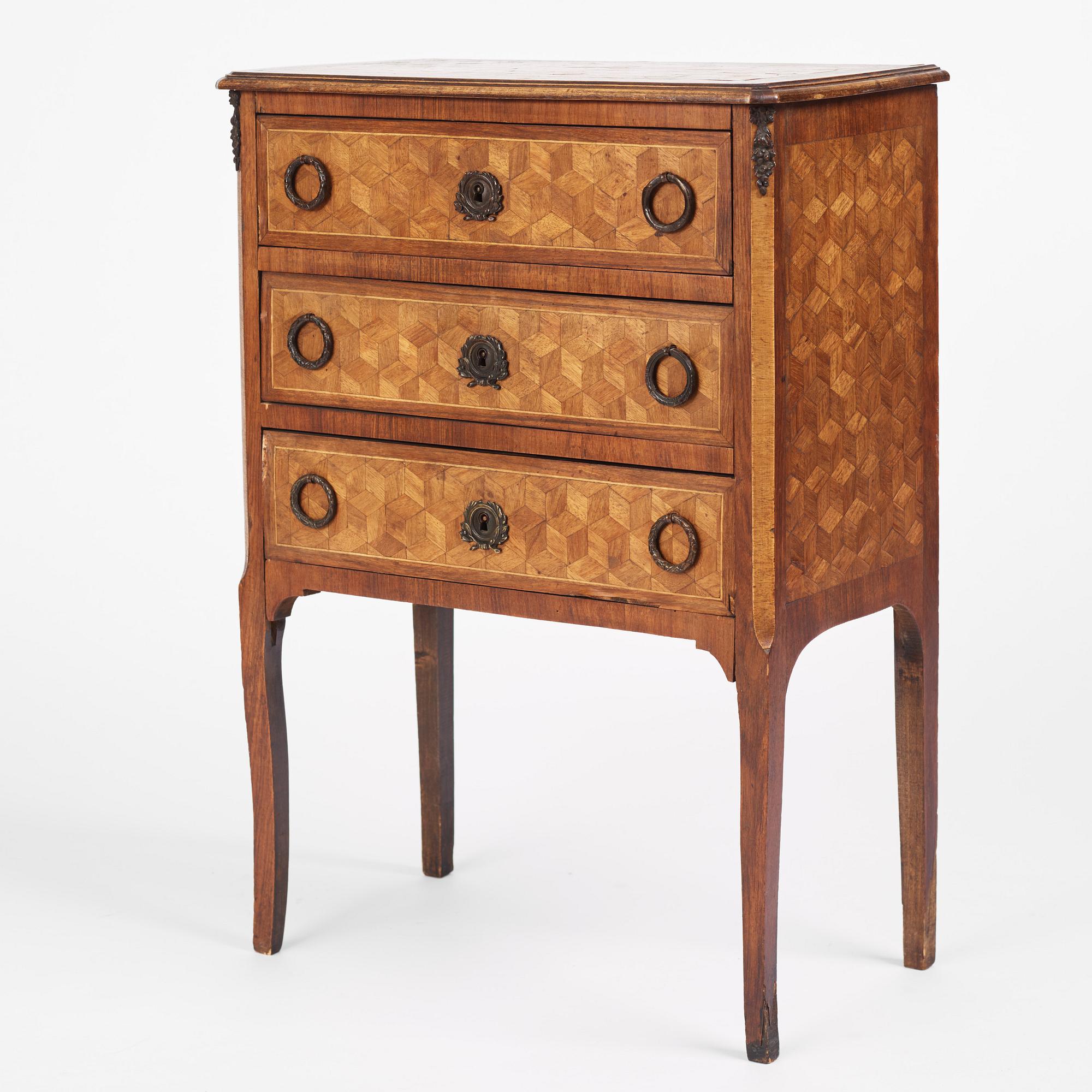 A Louis XVI-style parquetry commode, circa 1900.