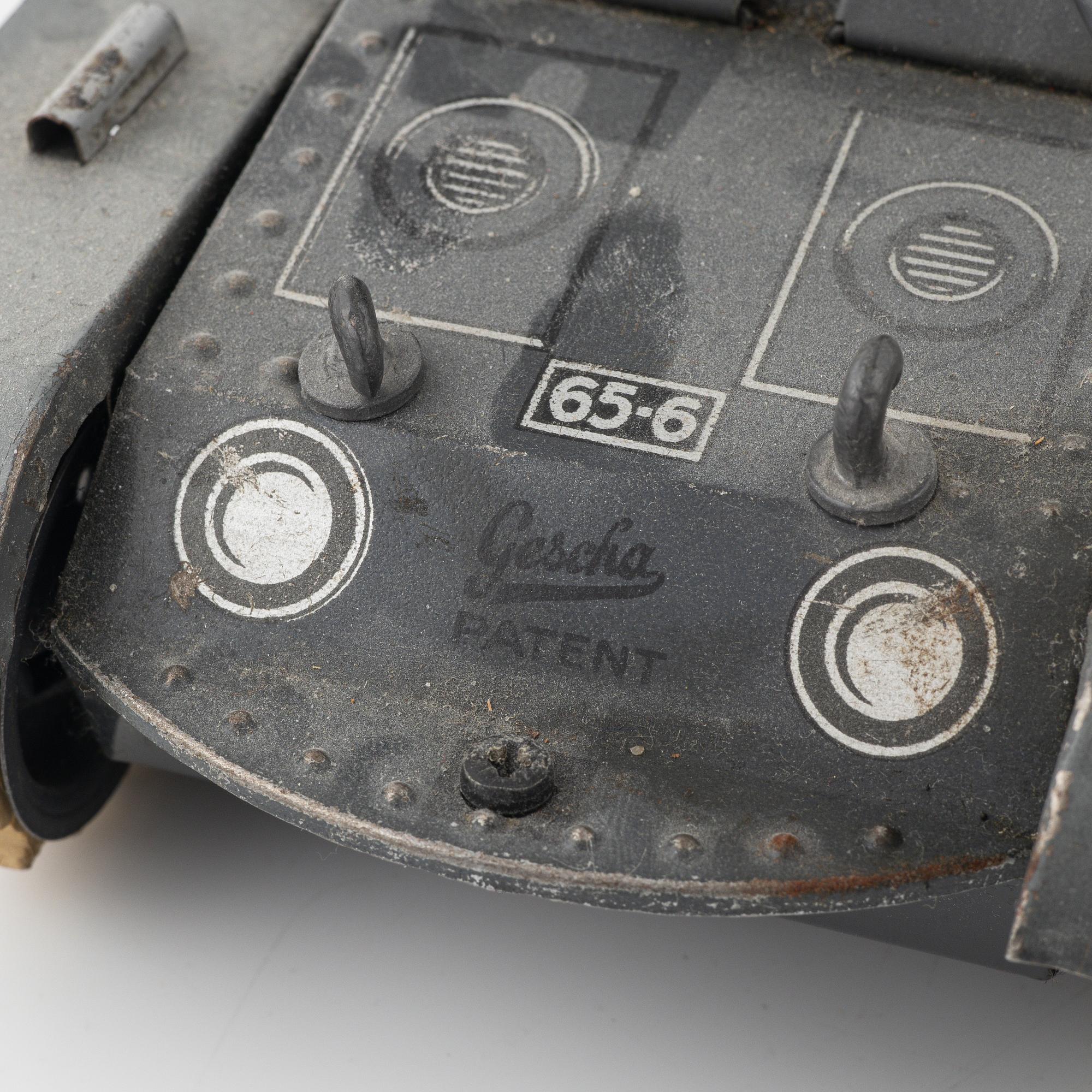 Three tin toys including a Gescha tank, Germany, mid 20th century.