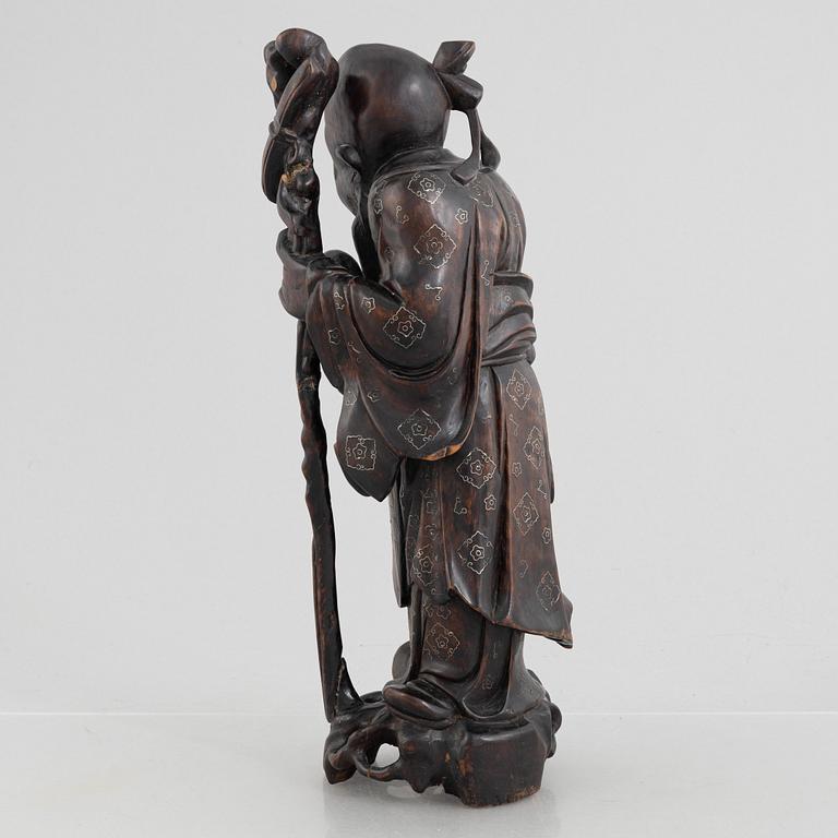 A Chinese wooden figure of 'Shoulao' with silver inlays, 20th century.