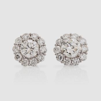1011. A pair of brilliant-cut earrings, total carat weight circa 3.90 cts.
