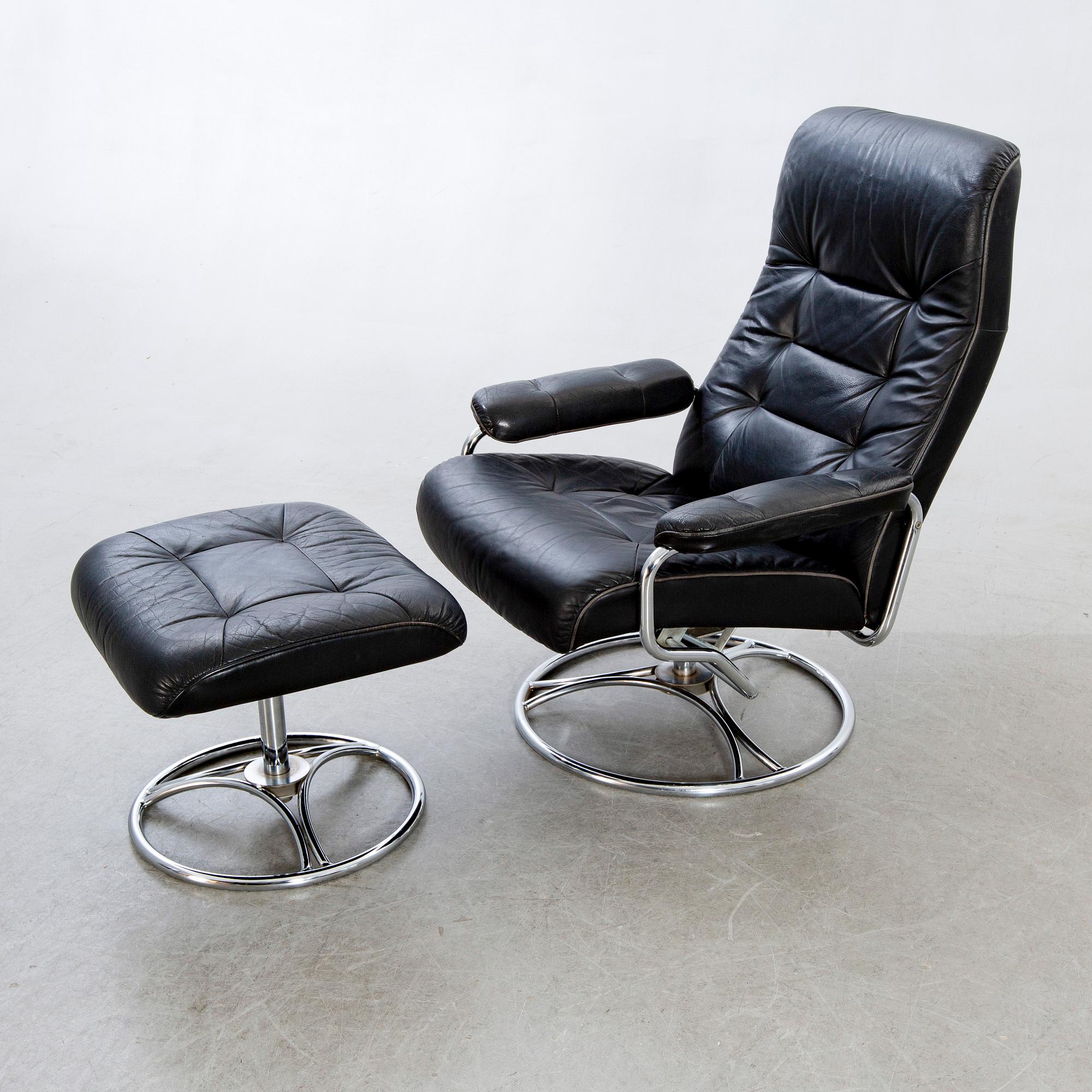 A leather swivel armchair and stool, Söderbergs  1980s.