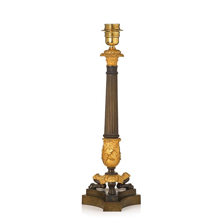 A French Empire ormolu and patinated bronze table lamp, early 19th century.