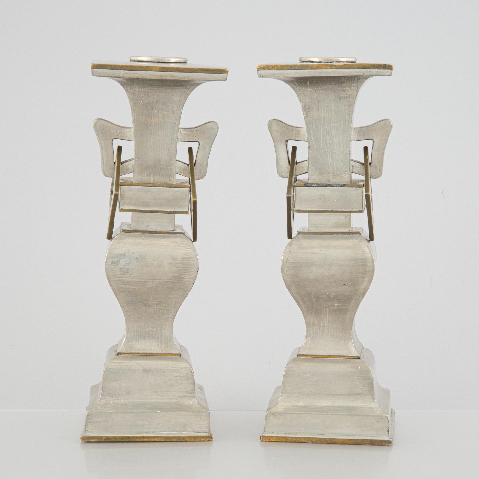 A pair of Chinese pewter and brass altar pieces, late Qing dynasty.