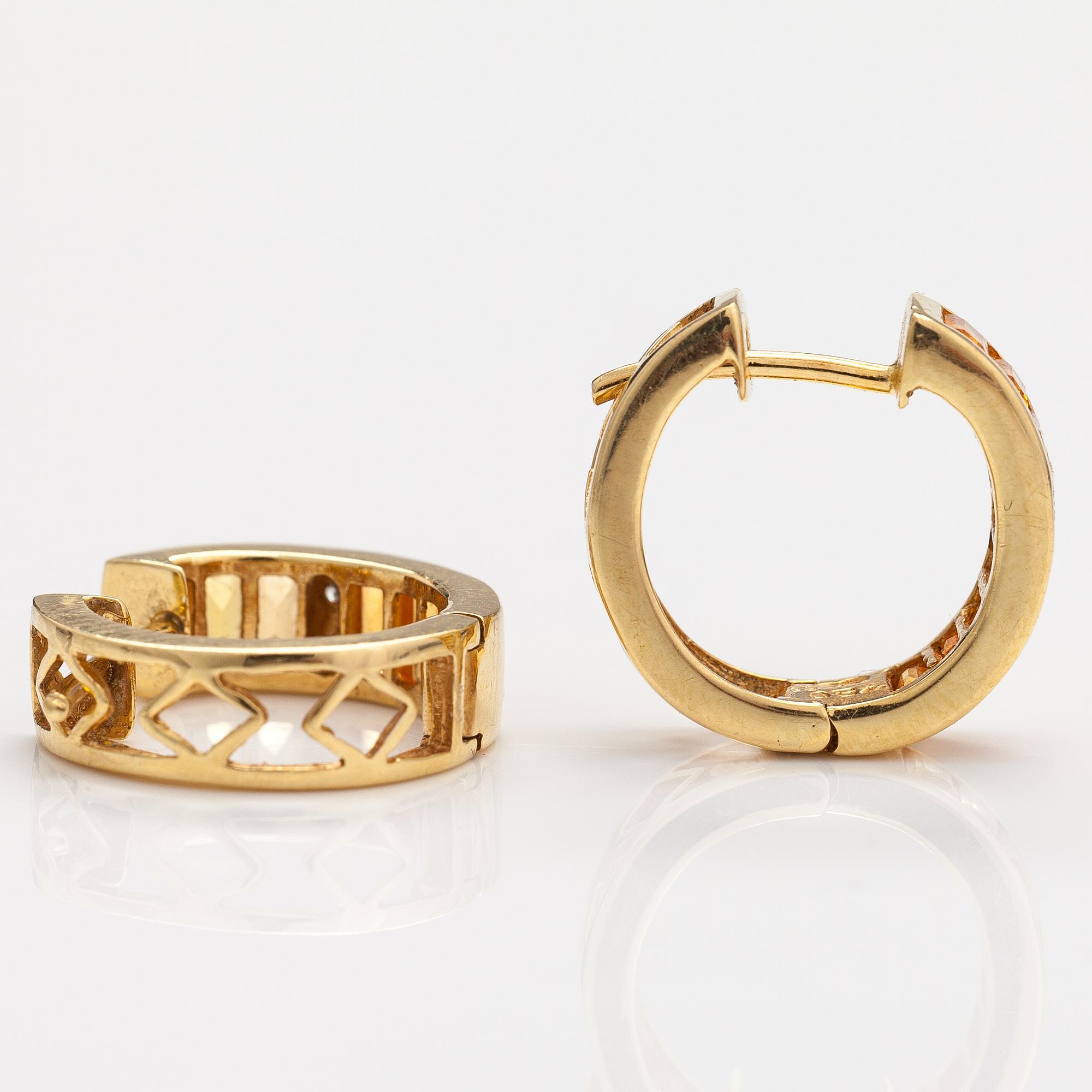 A pair of 18K gold earrings with yellow sapphires and ca 0.01 ct of diamonds.