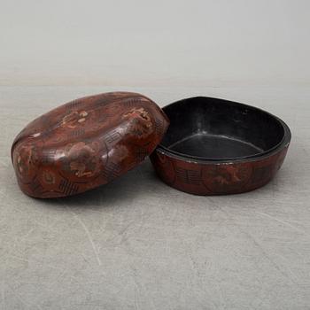 A massive Japanese wooden and lacquered box with cover, in the shape of a peach, early 20th century.