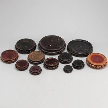 A set of 12 Chinese wooden stands, 19th and 20th Century.