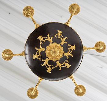 A patinated and ormolu six-light Empire chandelier, Stockholm, first part 19th century.