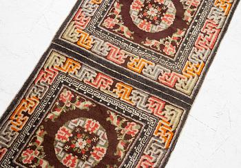 A Chinese two square rug, antique, c. 142 x 71 cm.