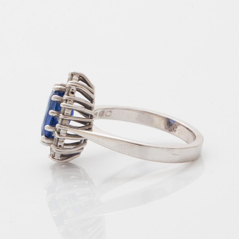 Oval faceted sapphire and brilliant-cut diamond ring.