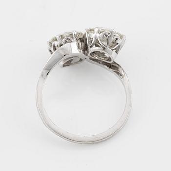 An 18K white gold cross over ring with old-cut diamonds.