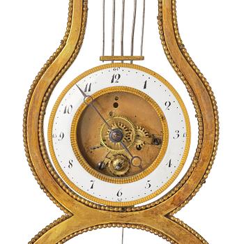 A French Louis XVI ormolu and marble lyre-shaped mantel clock, late 18th century.