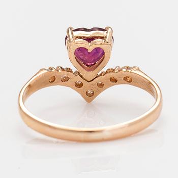 A 14K gold ring, with a heart-shaped ruby and diamonds.