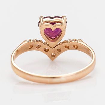 A 14K gold ring, with a heart-shaped ruby and diamonds.