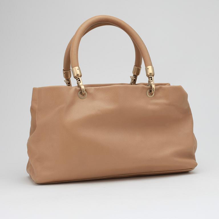 CHANEL, a beige leather handbag.