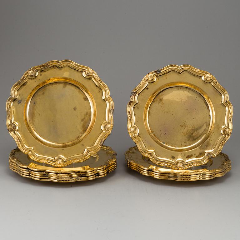 A German set of twelve 19th century silver-gilt plates, mark of Hossauer, Berlin. Rokoko-style.