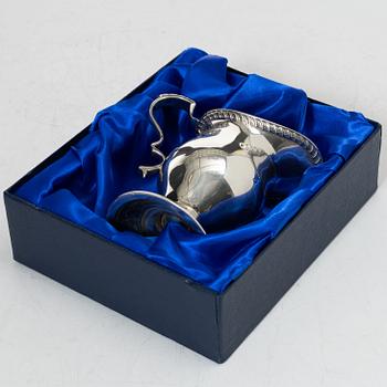 A silver cream jug, mark of S W Smith & Co, Birmingham, England 1929.