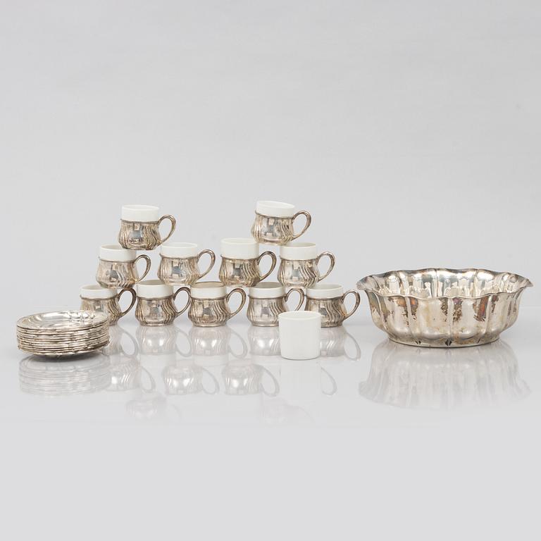 A set of eleven silver cups with saucers and a bowl, Germany, 20th Century.