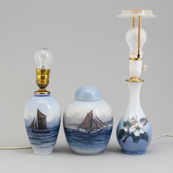 Two mid 20th century Royal Copenhagen porcelain table lights and a jar with lid.