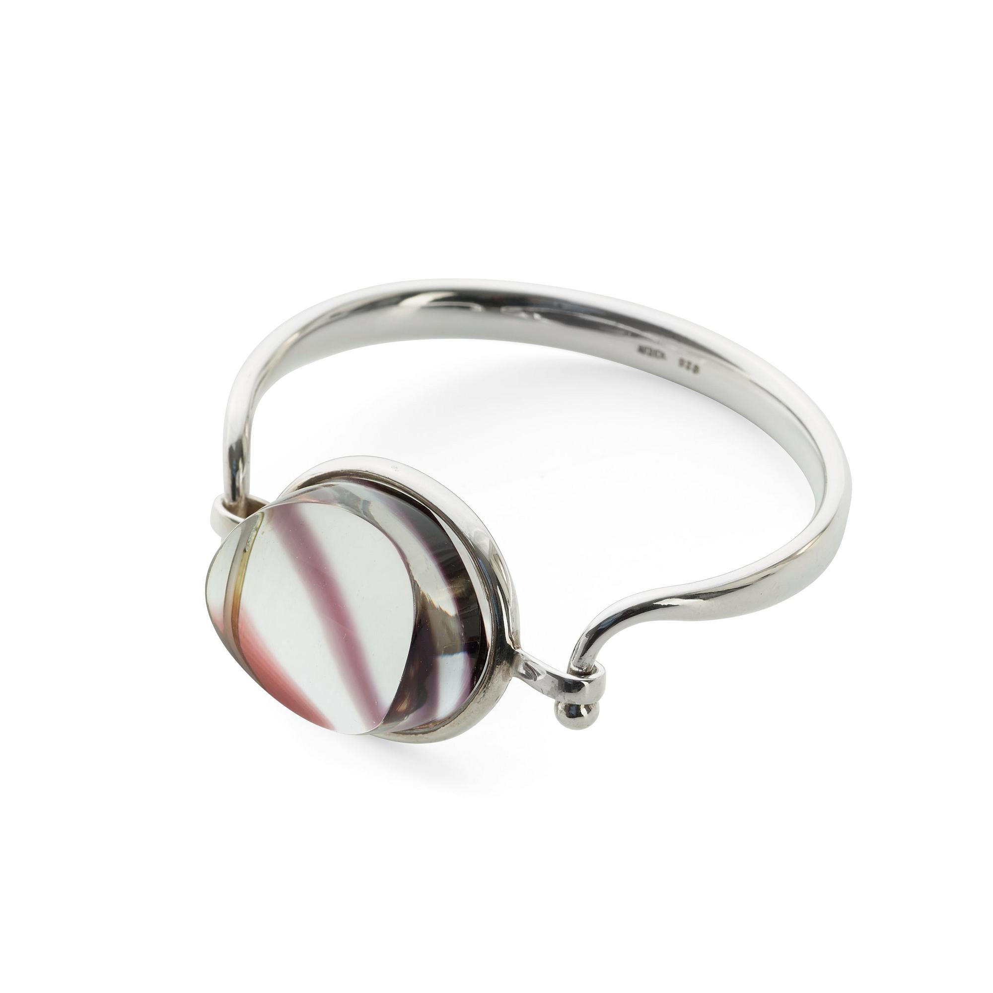 A Torun Bülow Hübe sterling bangle with a cut graal glass lock, ca 2001.