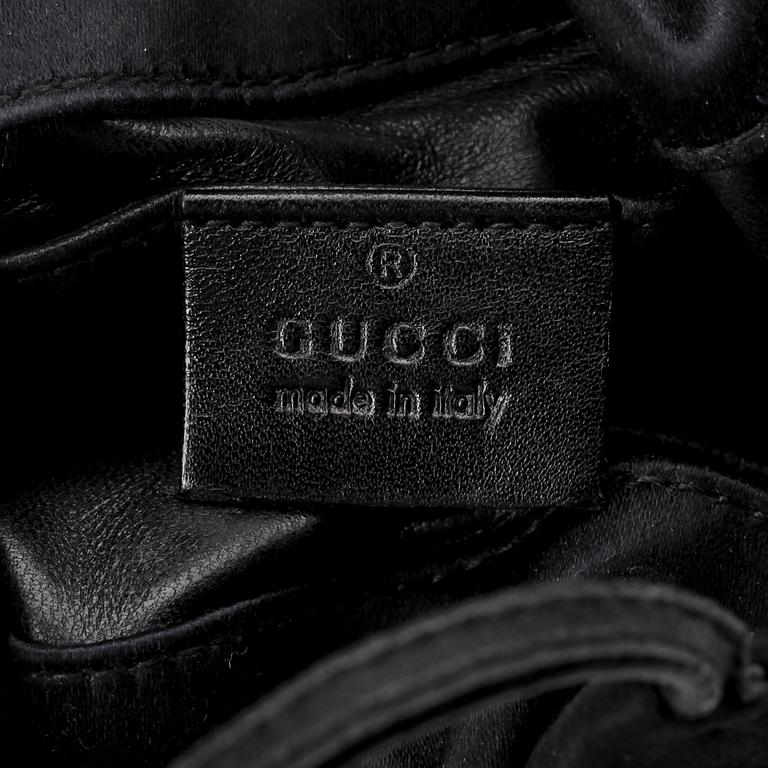 GUCCI, a black silk evening bag.