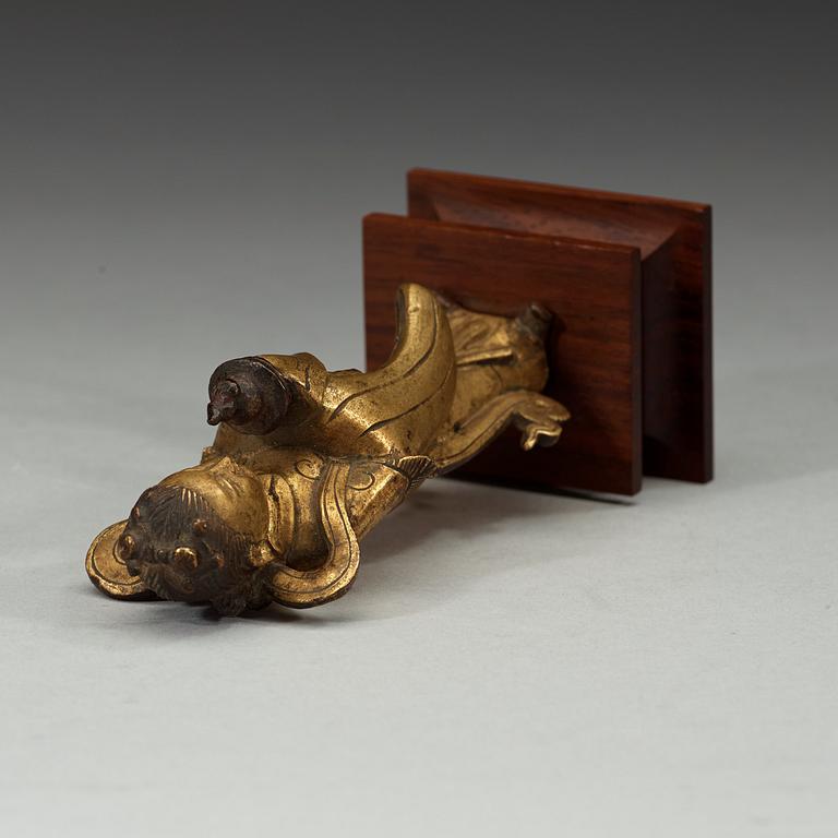 A gilt bronze figure of Longnü, Ming Dynasty, 17th century.