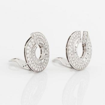 A pair of 14K gold earrings set with round brilliant- and baguette-cut diamonds.