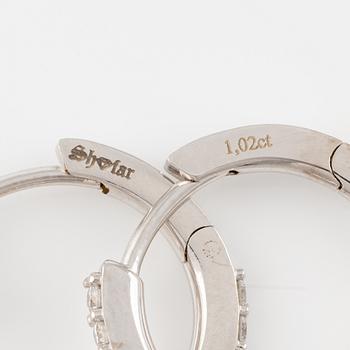 A pair of 18K gold earrings with round brilliant-cut diamonds.