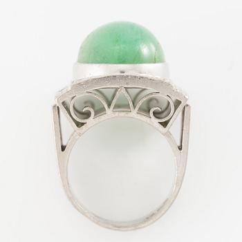 An 18K white gold ring set with a cabochon-cut emerald and round- and eight-cut diamonds.