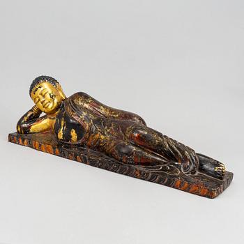 A large gilt and lacquered figure of reclining buddha, Thailand, circa 1900.