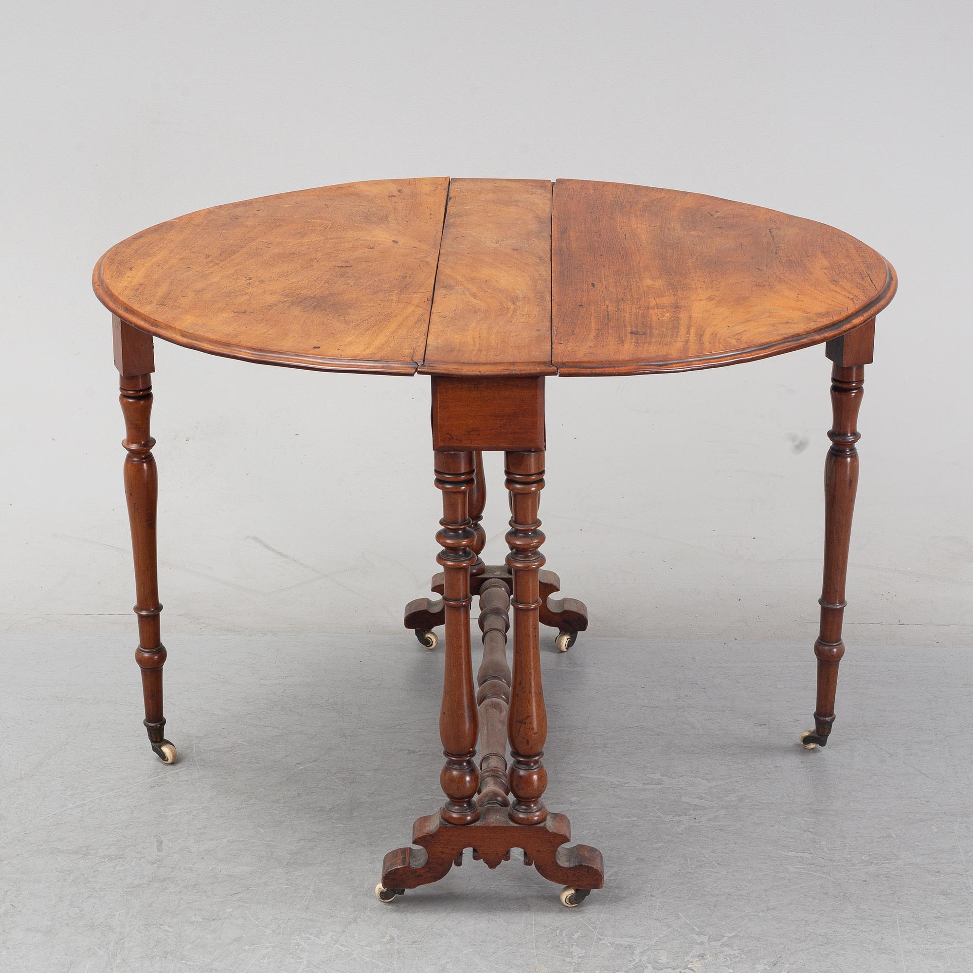 A neo-renaissance mahogany drop-leaf table from secord half of 19th century.