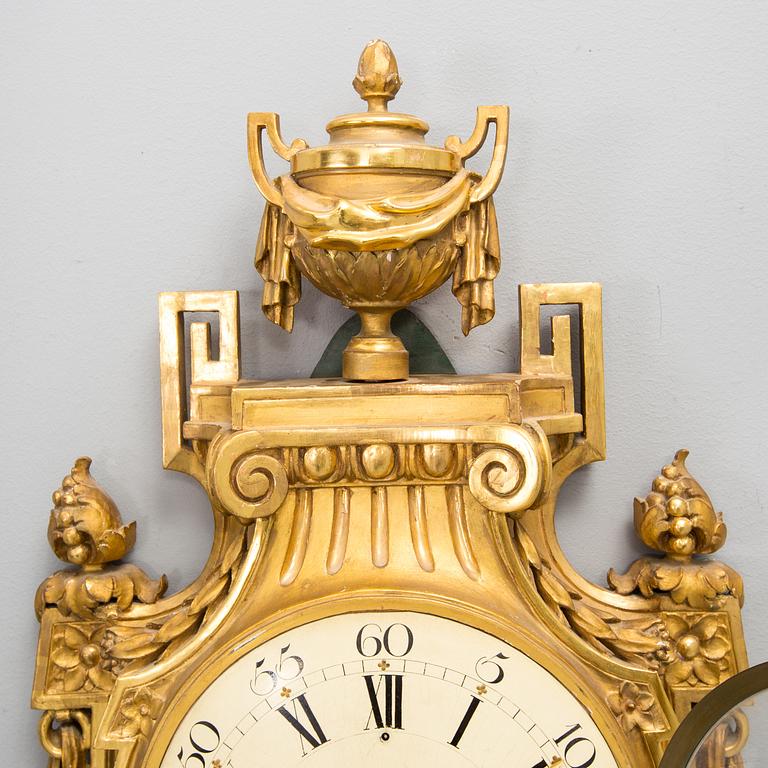 A wall clock in gustavian style, marked Rob. Engström, Stockholm.