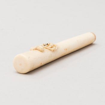 A Russian carved bone pen handle.