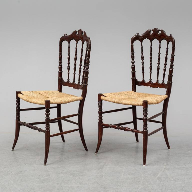 A pair of Chiavari chairs.