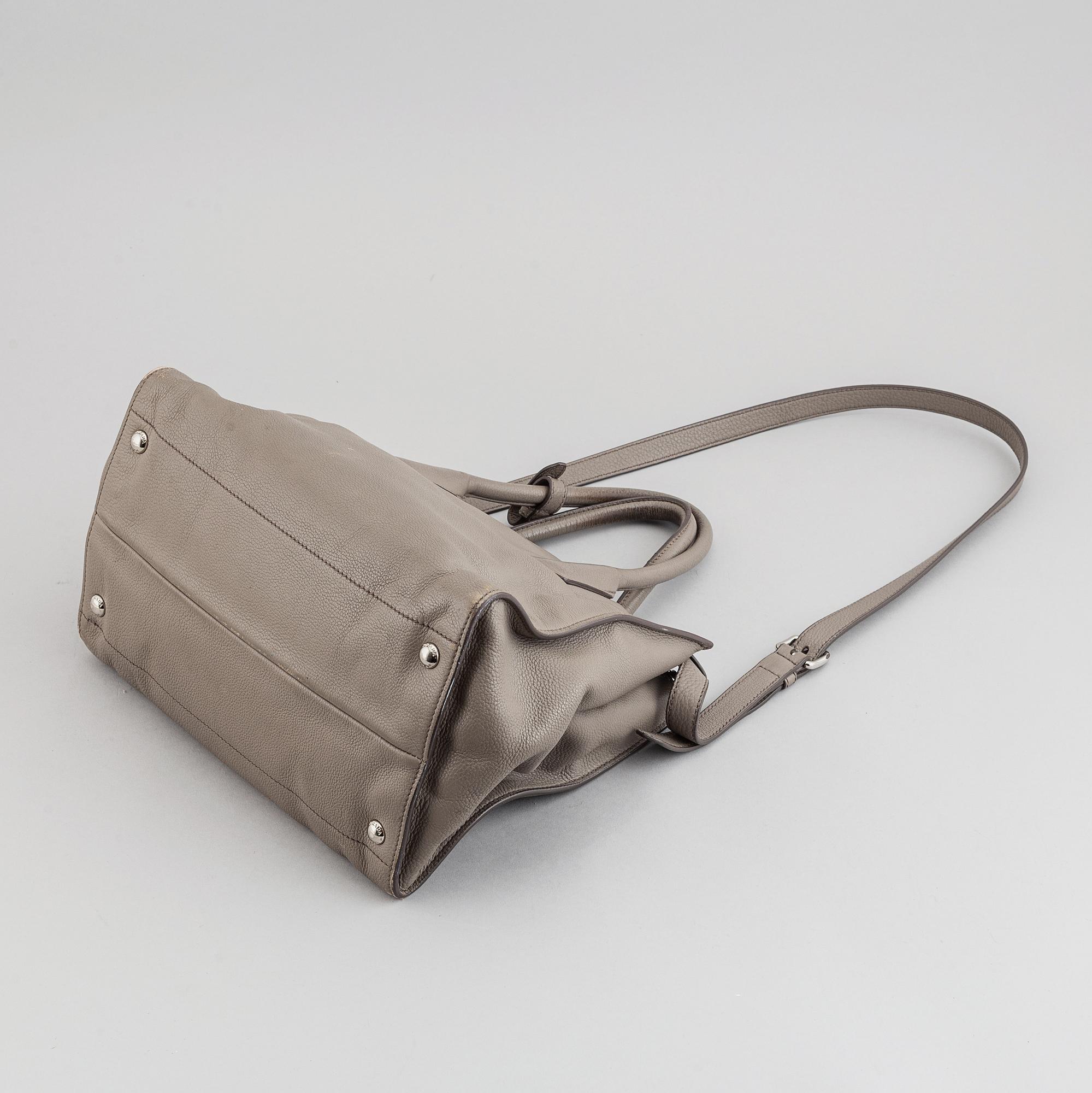 Prada, a leather handbag.