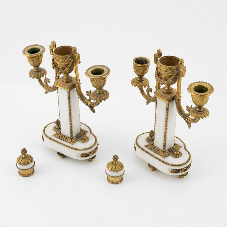 A pair of Louis XVI-style marble two-light candelabra, mid 20th Century.