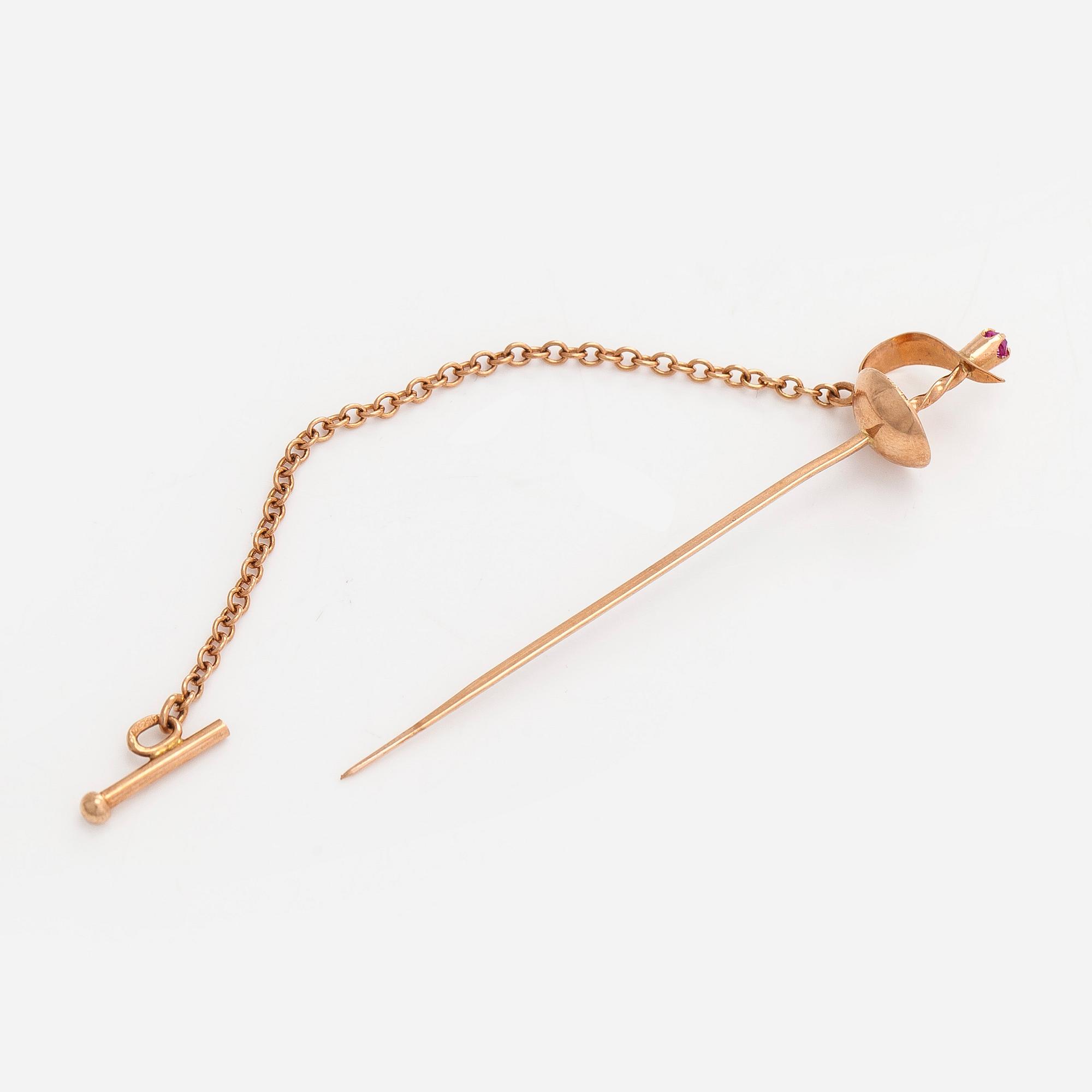 Tie pin, sword,  in 14K gold with a synthetic spinel. Soviet Union, late 20th century.